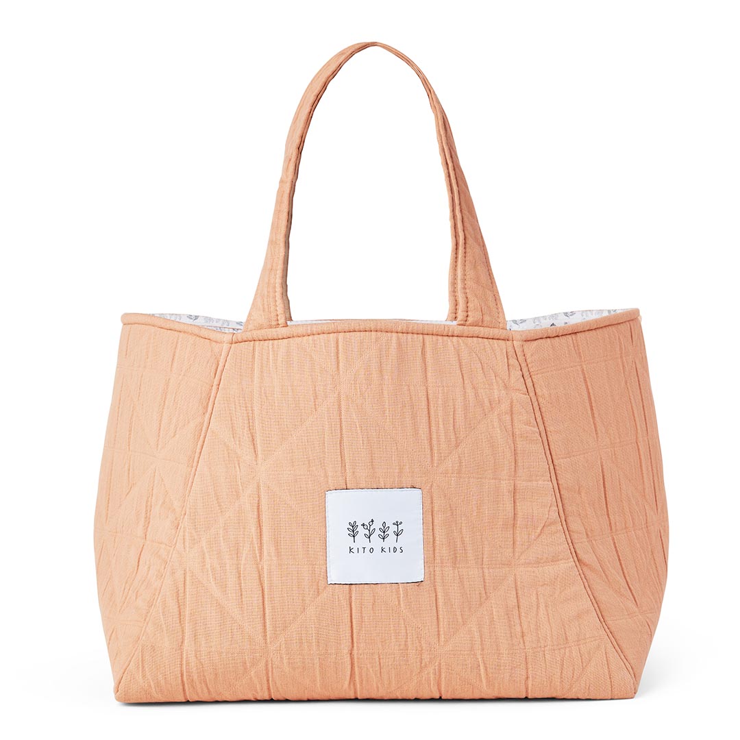 Sac de transport pour affaires de bébé en mousseline douce terracotta et pêche.